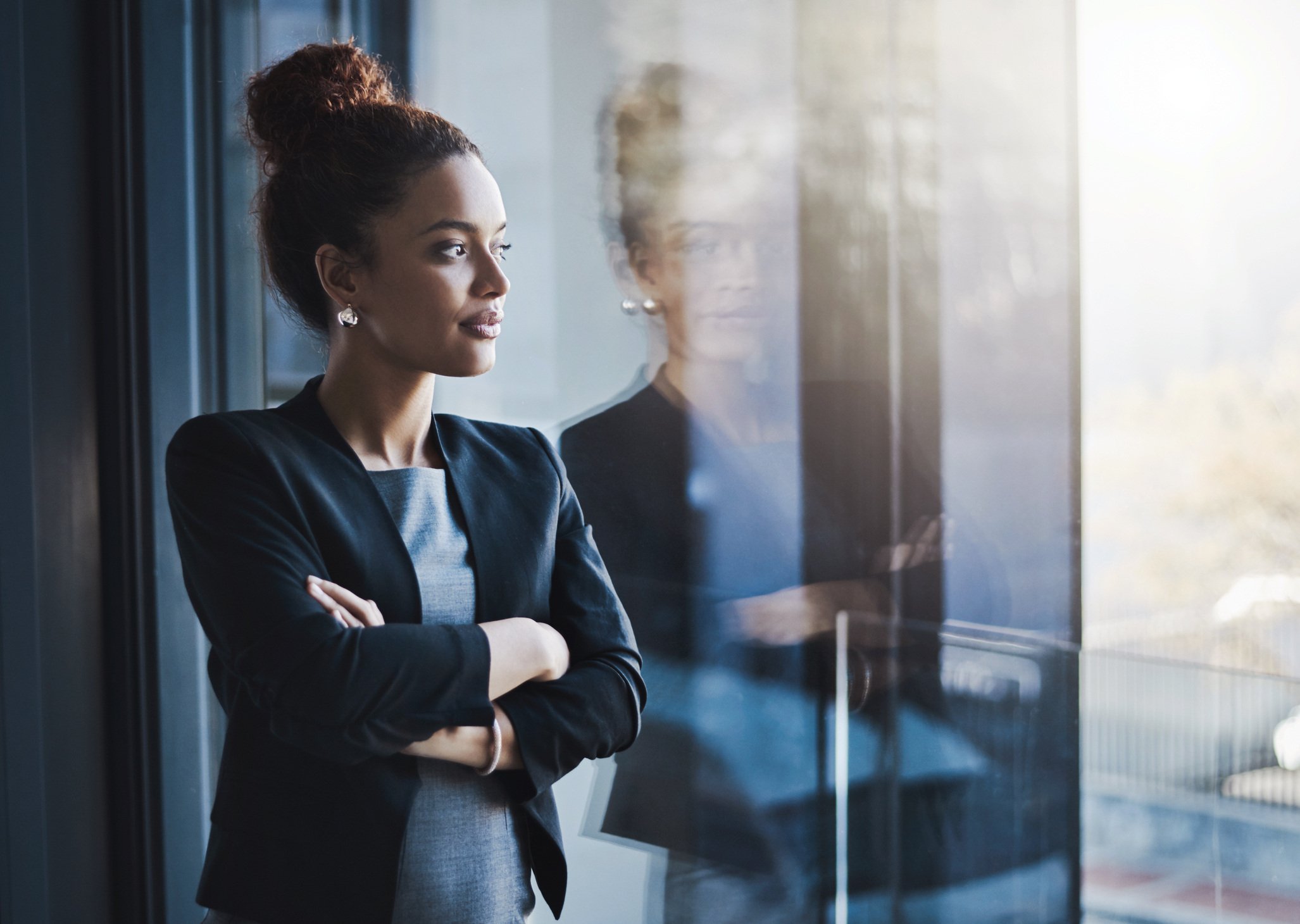 Women Looking out the window -iStock-1004114252